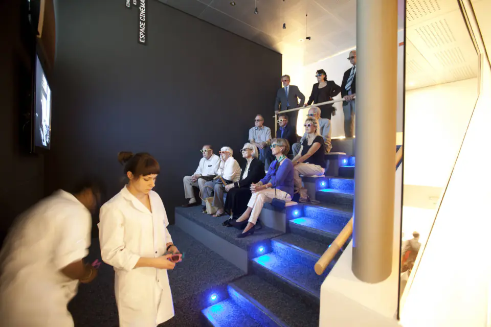 Watchmaking demonstration in front of visitors seated on tiered benches