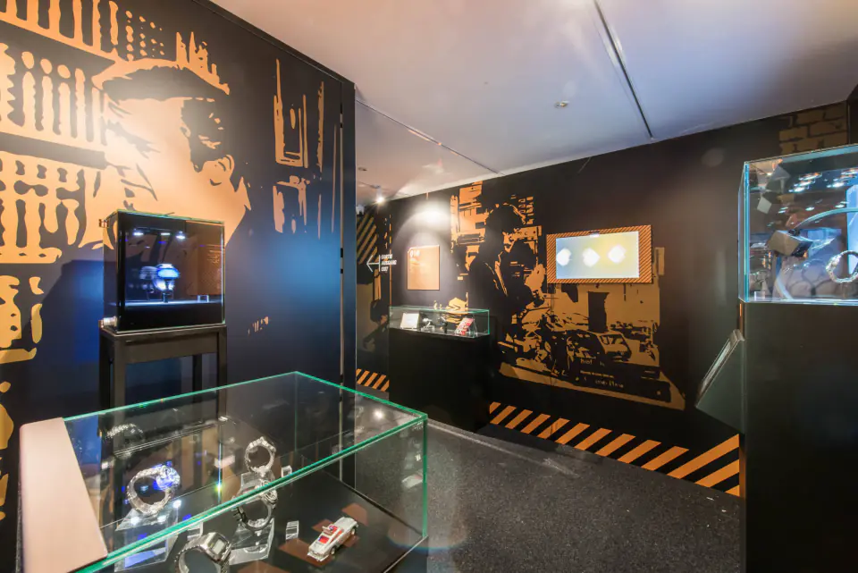Dark room and display cases of the James Bond Time exhibition