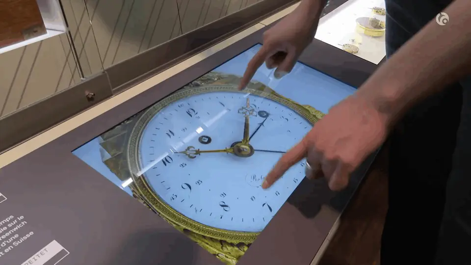 Interactive touch table displaying the dial of an antique clock